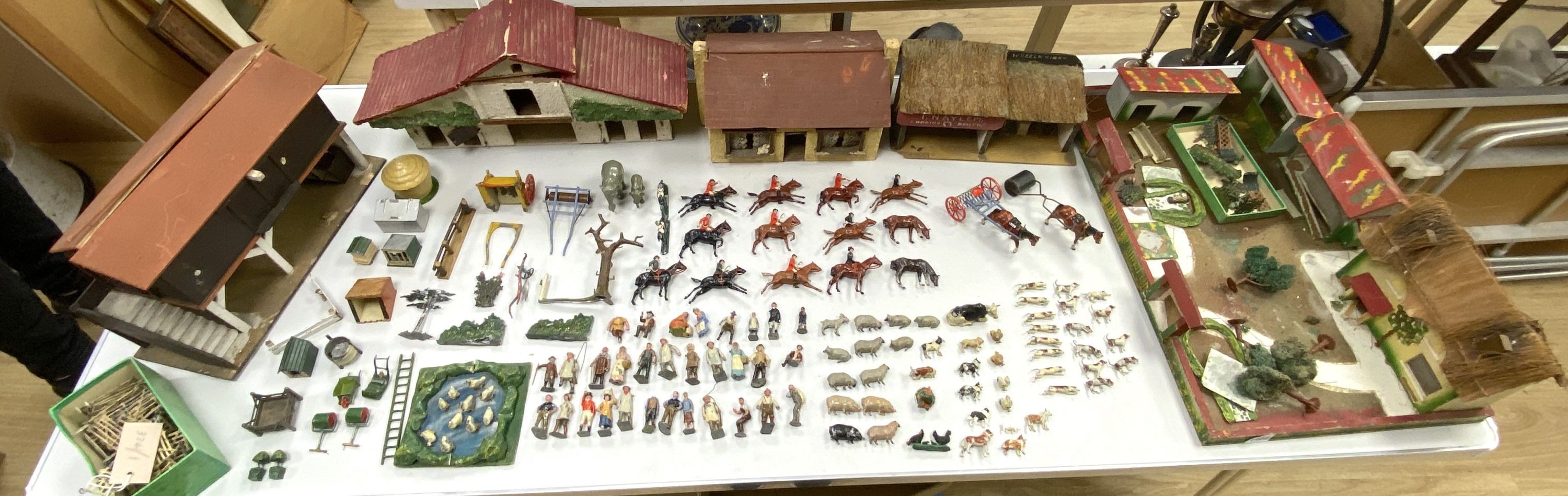A collection of mainly Britains painted lead figures and animals, including huntsmen and hounds, farm workers, animals and wooden buildings
